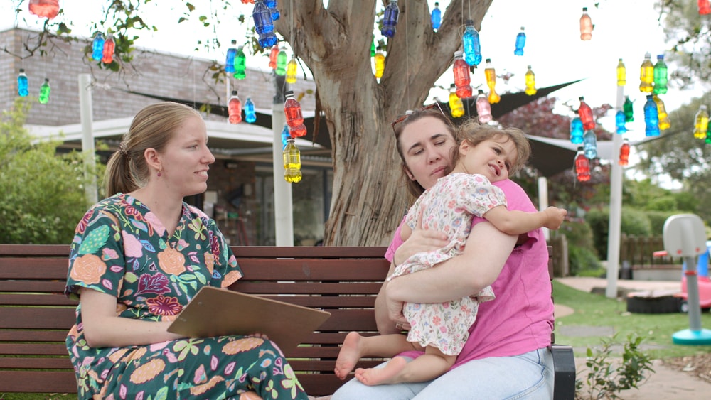 Clinician talking with family outside