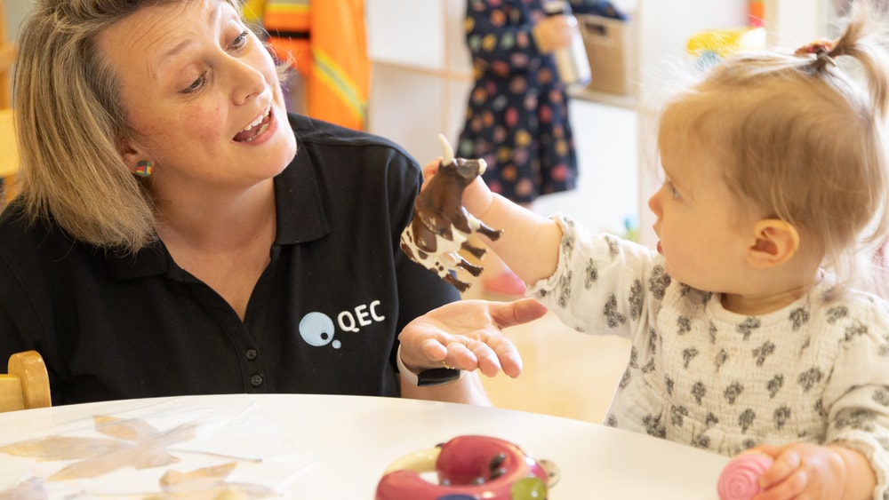 QEC clinician interacting with baby in QEC PlayRoom.