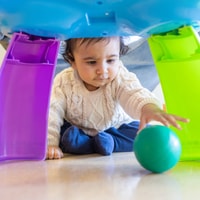 Baby crawling after ball in QEC PlayRoom.