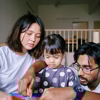 Parents supporting child with disability