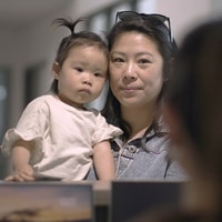 Parent and toddler talking to receptionist 2