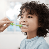 Parent brushing childs team