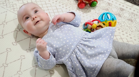 Baby laying on mat
