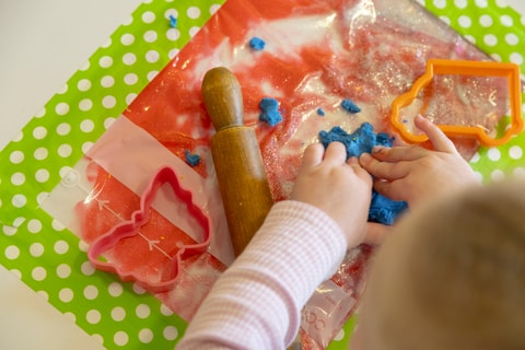 Child playing with Play-Doh in QEC PlayRoom.