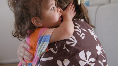 Young child hugging/holding onto parent