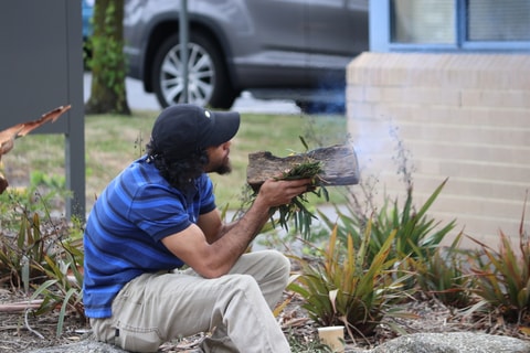 A smoke ceremony performed at QEC.