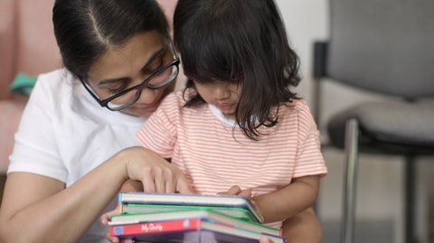 Parent reading book with child