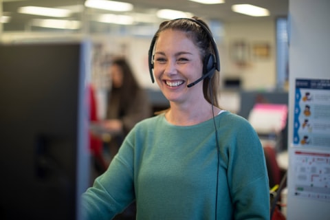 QEC staff member speaking to a family over the phone.