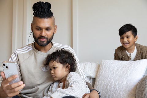 Parent using mobile telehealth - sad child